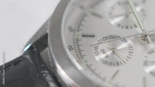 Counting time metallic wristwatch. Macro shot. Close up.