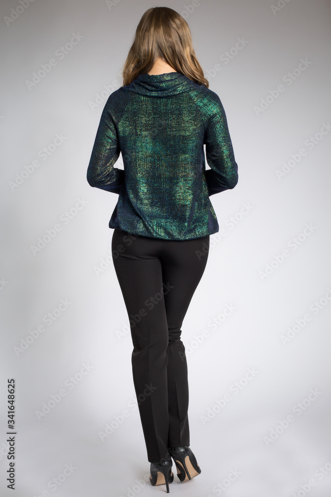 Beautiful blonde model posing in green shirt and black pants Beautiful blonde model posing in green shirt and black pants