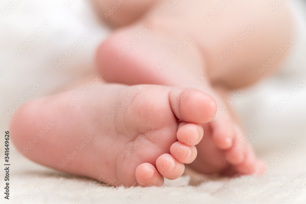baby feet close-up, newborn lying on the bed baby feet close-up, newborn lying on the bed