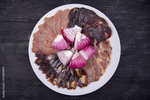 Meat plate with meat stock with red onions photo