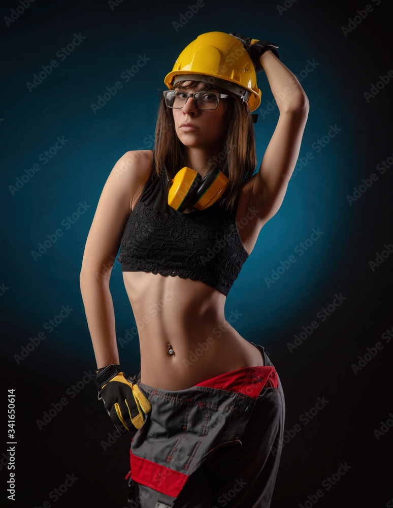 Girl in overalls with a chainsaw Girl in overalls with a chainsaw