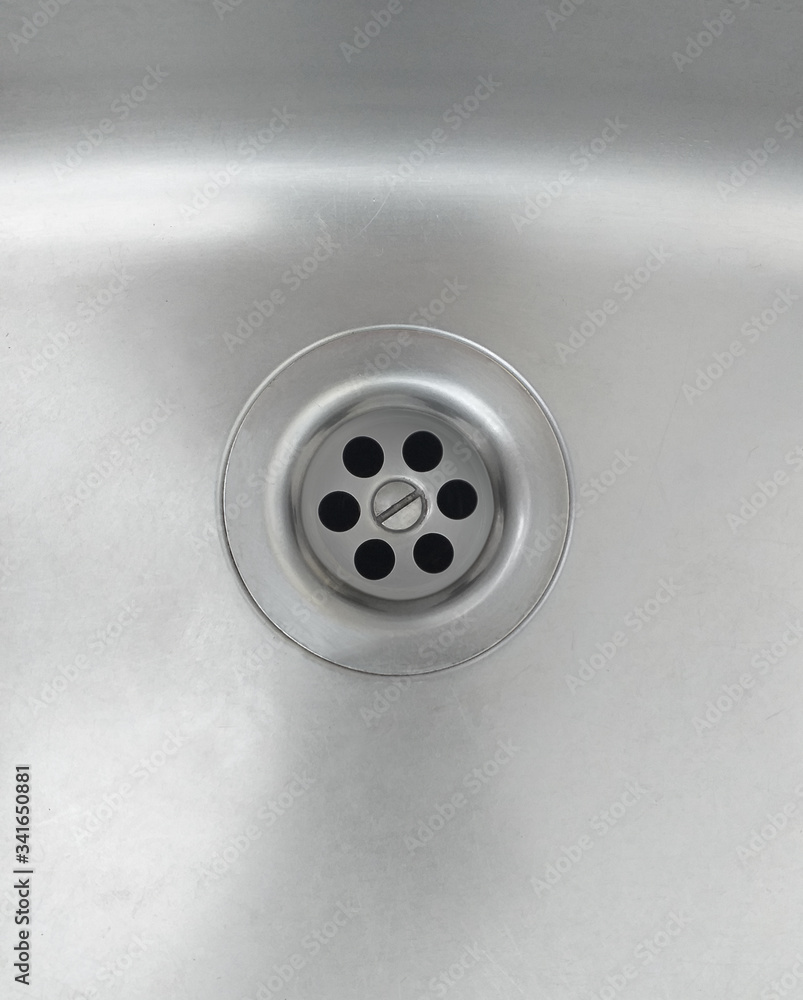 Aerial view of high quality stainless steel kitchen sink. Close up of Brilliant home drain. Aerial view of high quality stainless steel kitchen sink. Close up of Brilliant home drain.