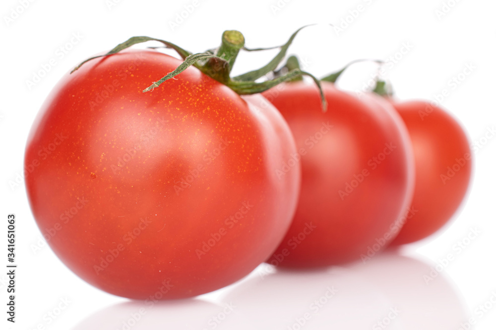 Group of three whole fresh red cherry tomato in row isolated on white Group of three whole fresh red cherry tomato in row isolated on white