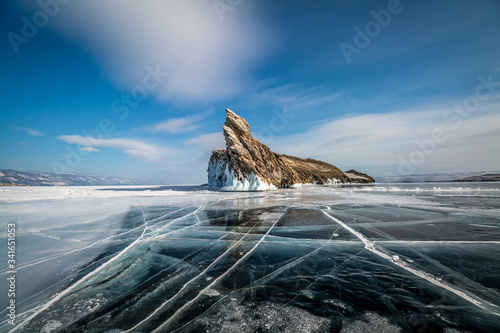 Ogoy island on lake Baikal in winter, transparent ice with cracks