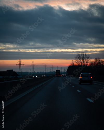 Traffic on the main highway through the landscape of Skåne (Scania) in southern Sweden during a winter sunset. © Michael Persson