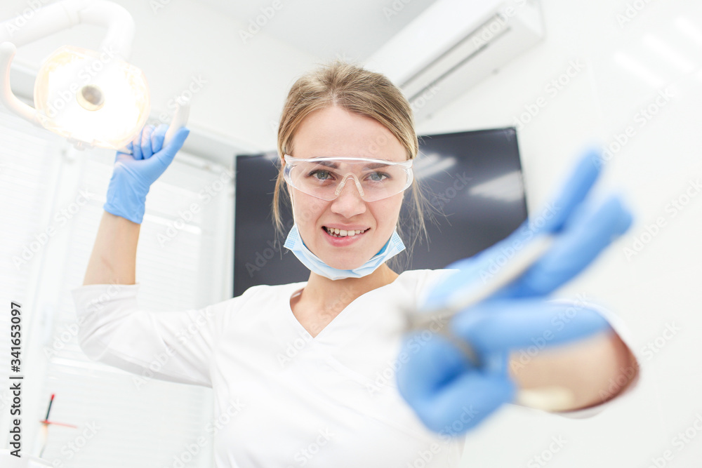 Charming dentist doing examenation of her patient mouth. Selective focus Charming dentist doing examenation of her patient mouth. Selective focus