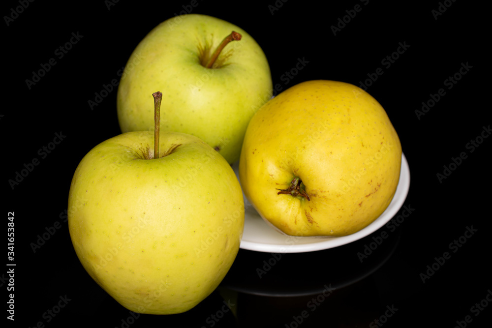 Group of three whole green delicious apple isolated on black glass Group of three whole green delicious apple isolated on black glass