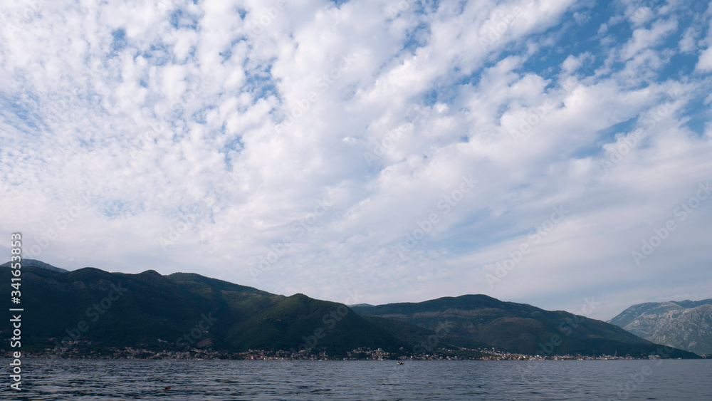 Sea, mountain and sky covered with white clouds - Kotor Bay, Montenegro, Europe.
