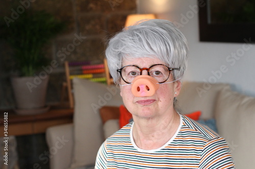 фотографія Senior woman wearing pig-style nose