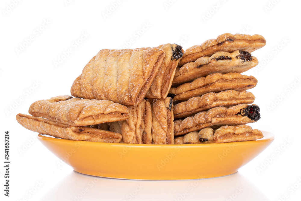 Lot of whole square puff cookie with raisins on yellow plate isolated on white