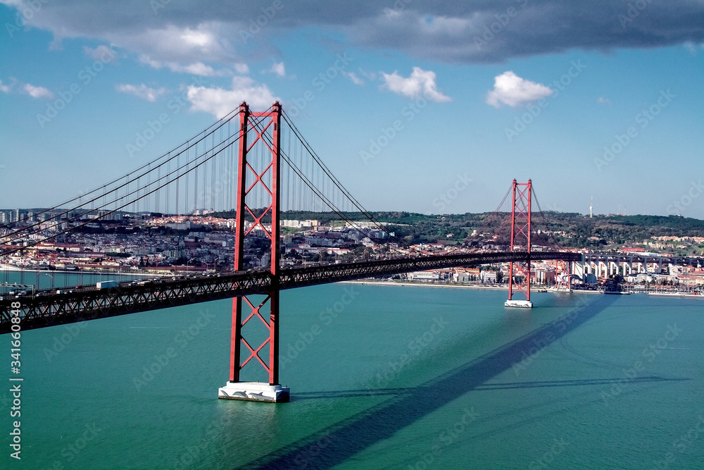 Fototapeta premium 25th of April Bridge over the Tagus river, connecting Almada and Lisbon in Portugal