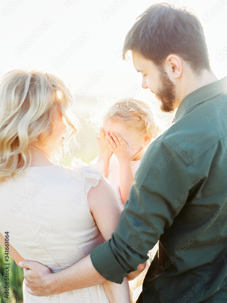 Happy family concept - father, mother and child daughter having fun and playing in nature. Happy family concept - father, mother and child daughter having fun and playing in nature.