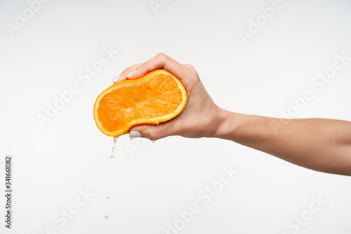 Obraz na plátně Side view of young attractive lady's hand being raised while pressing half of or