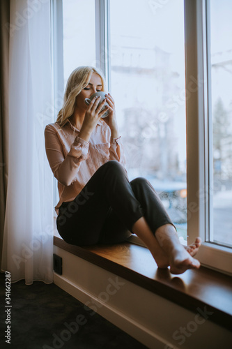 Young woman with cup of tea...