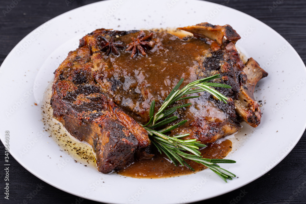 Fried pork meat baked in an oven with sauce and spices Fried pork meat baked in an oven with sauce and spices