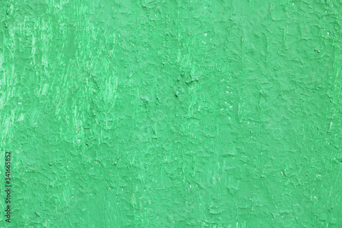 Beautiful vintage green background with old green paint with a rough surface, streaks and uneven texture of green paint on an old rough surface © yarbeer