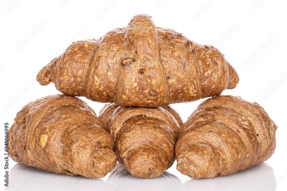 Group of four whole baked wholegrain croissant isolated on white