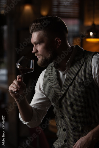 Professional sommelier man with a glass of red wine.