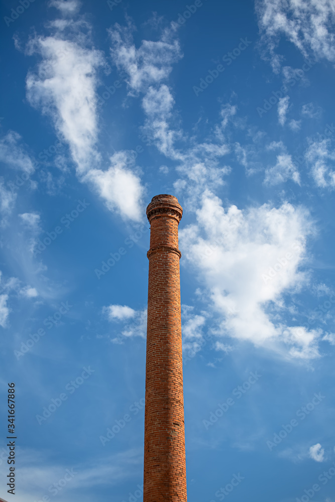 View of a industrial chimney made with orange massive brick