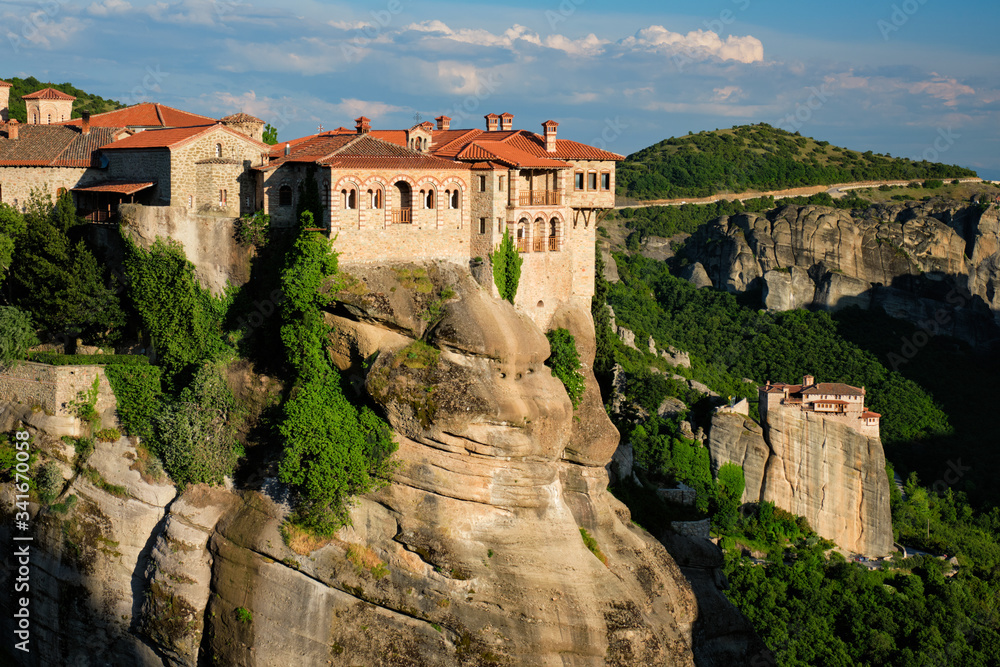 Monastery of Varlaam monastery and Monastery of Rousanou in famous greek tourist destination Meteora in Greece on sunset with scenic scenery landscape