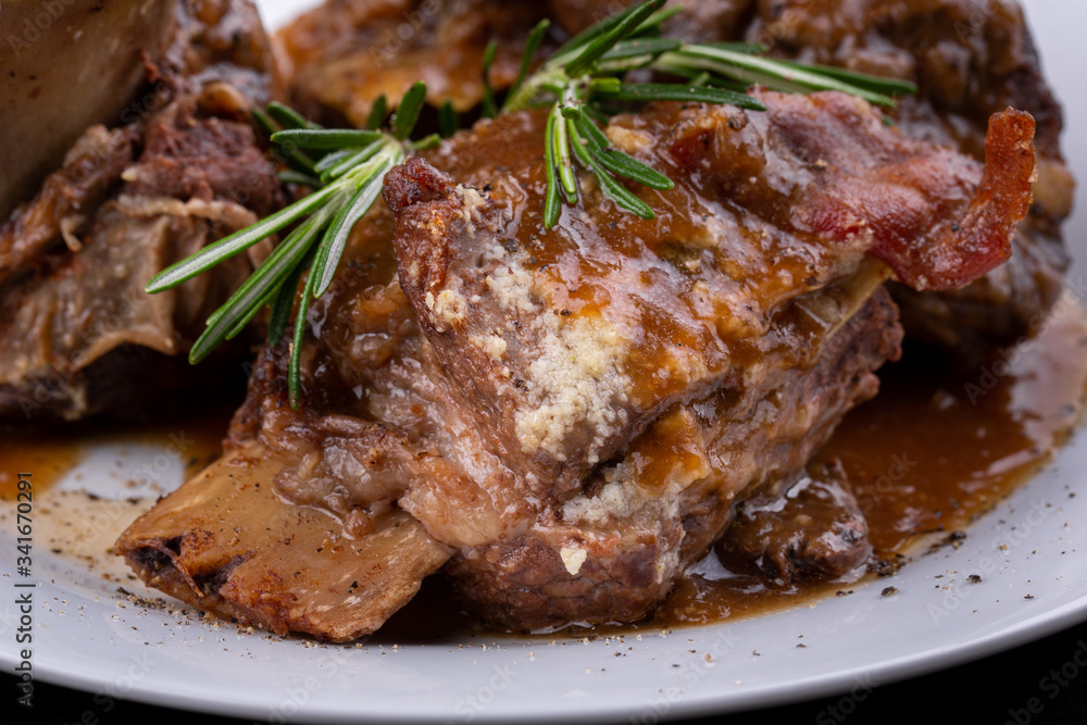 Meat on the bone baked with spices is served with sauce Meat on the bone baked with spices is served with sauce