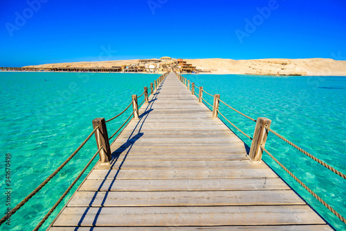 Wooden Pier at Orange Bay Beach with crystal clear azure water and white beach - paradise coastline of Giftun island  Mahmya  Hurghada  Red Sea  Egypt.