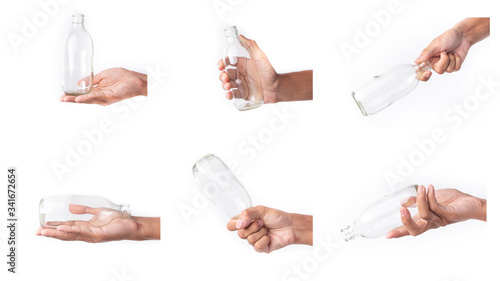 holding glass bottle with water on white background. Hand holding variation of object.