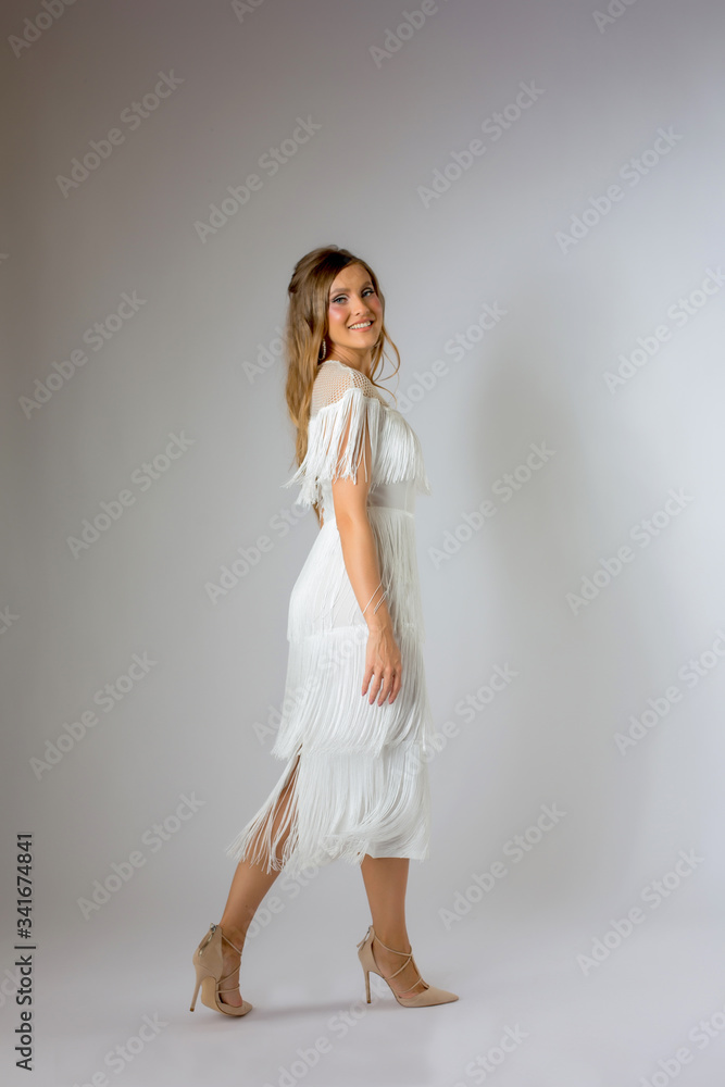 Blonde model take photos in white fashion dress Blonde model take photos in white fashion dress