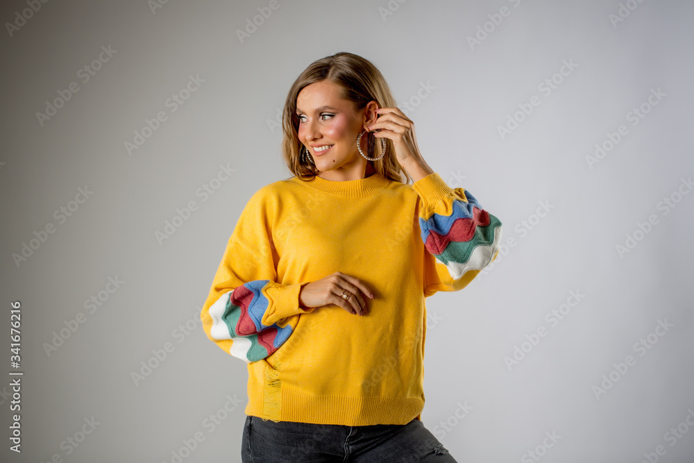 Beautiful blonde woman posing in yellow blouse Beautiful blonde woman posing in yellow blouse