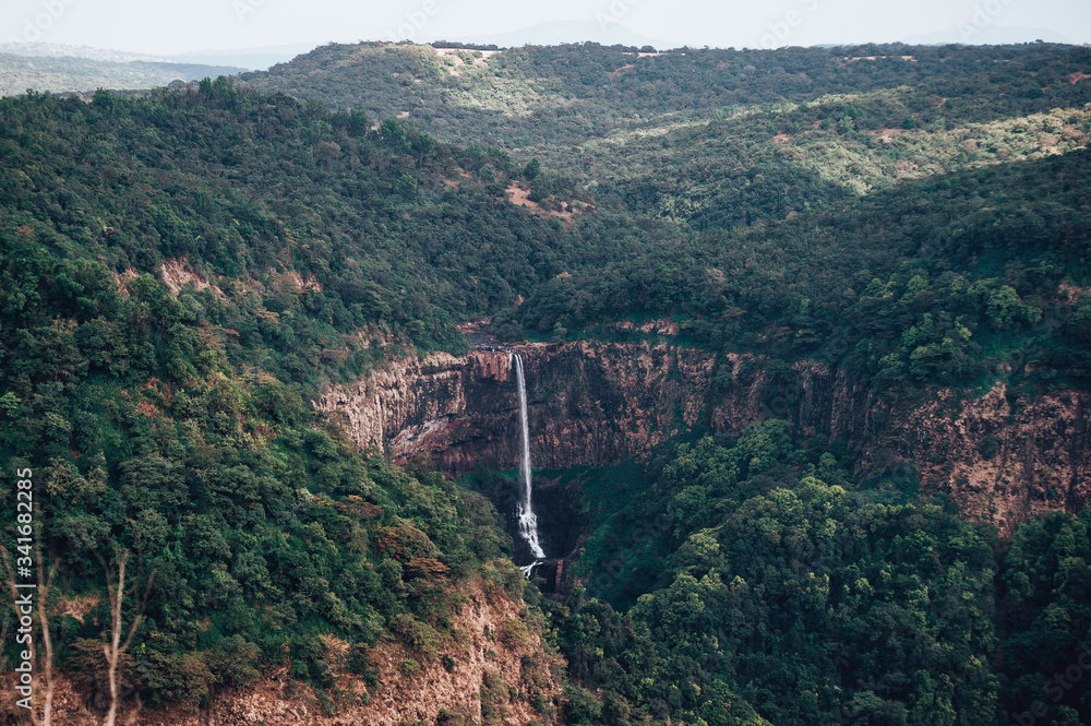 View of Surla or Sural waterfall in Goa and the green valley and mountains  surrounded