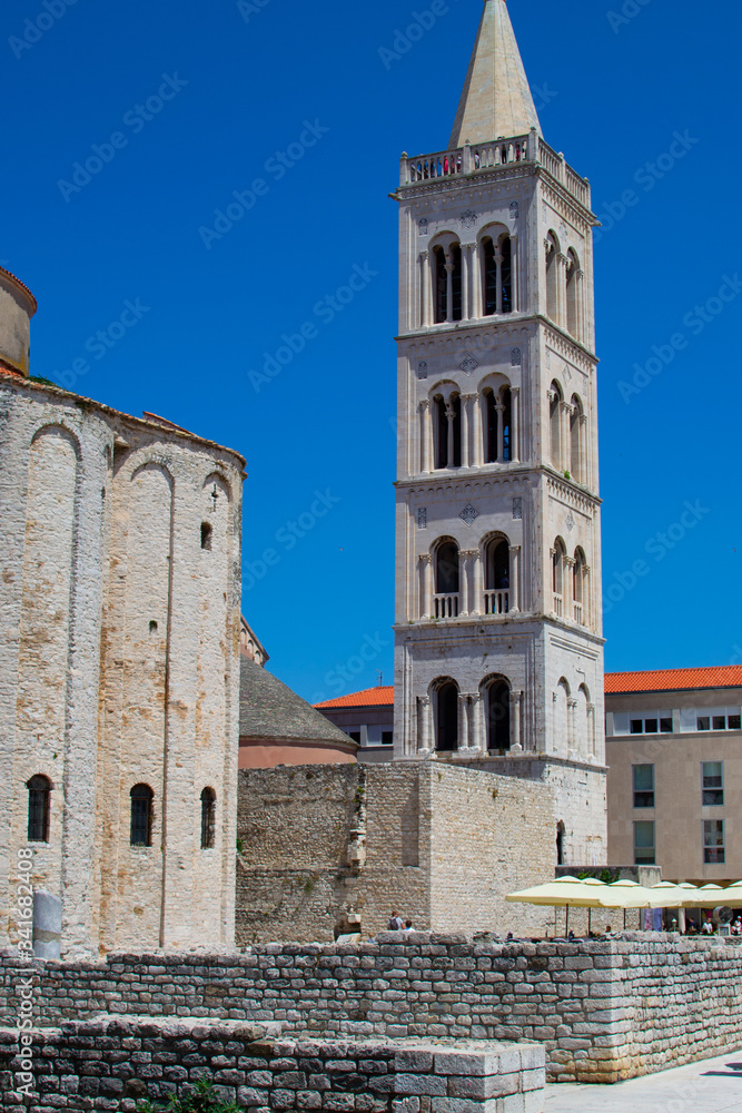 Vertical picture of the Roman Forum of Zadar, Croatia, with the Bell Tower of the Cathedral of St. Anastasia at the background