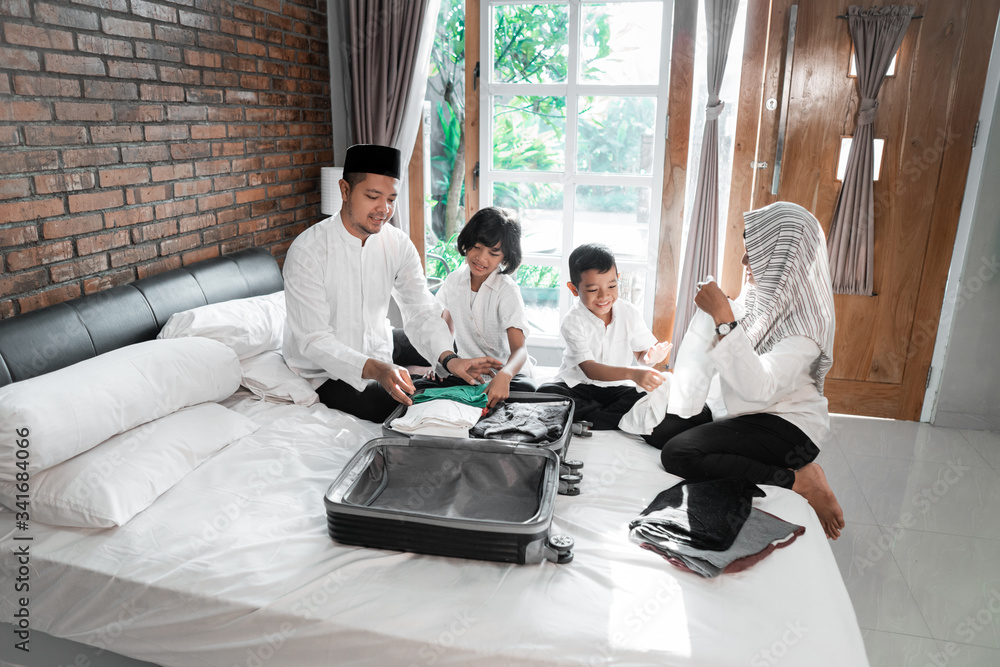 Muslim family prepare clothes and suitcase for carried when mudik go to the village Muslim family prepare clothes and suitcase for carried when mudik go to the village