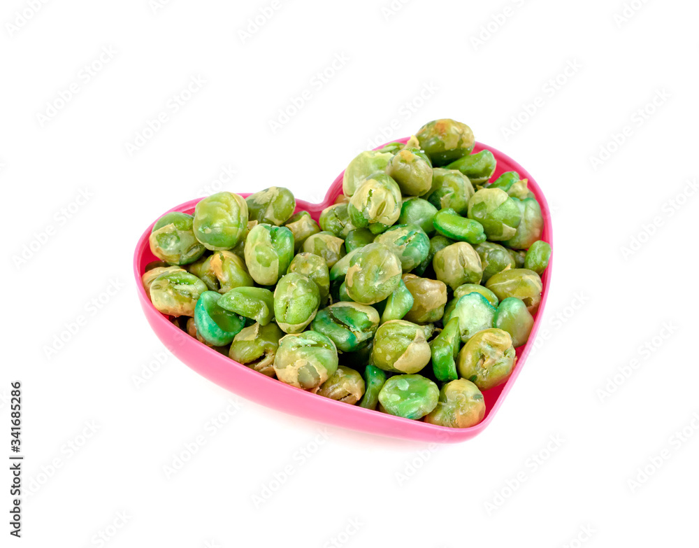 Green peas roasted with pink heart shaped cup isolated on white background Green peas roasted with pink heart shaped cup isolated on white background