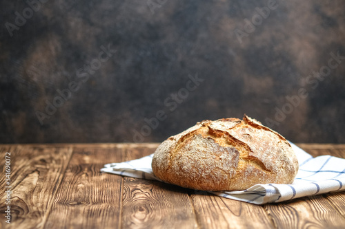 Delicious homemade bread on a napkin on rustic background.