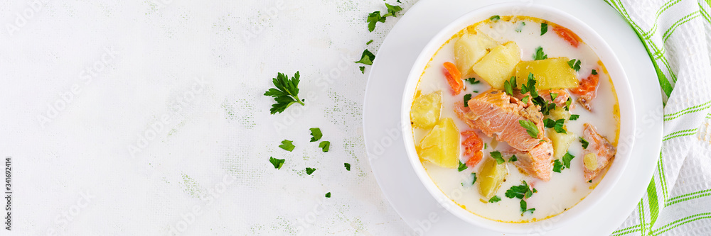 Kalakeitto. Creamy soup with salmon, potatoes, onions and carrots and in a bowl. Finnish/ karelian cuisine. Lohikeitto. Top view, overhead, banner Kalakeitto. Creamy soup with salmon, potatoes, onions and carrots and in a bowl. Finnish/ karelian cuisine. Lohikeitto. Top view, overhead, banner