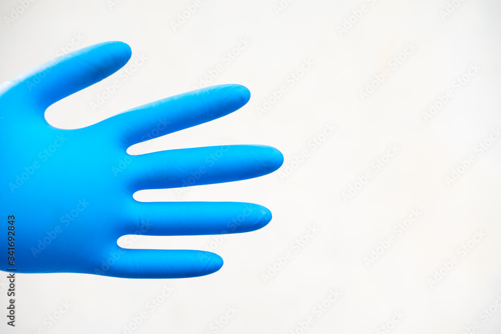 Close up hand in blue glove. Close up hand in blue glove.