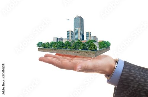 Businessman holds in his hand a piece of land with business district. 3d illustration