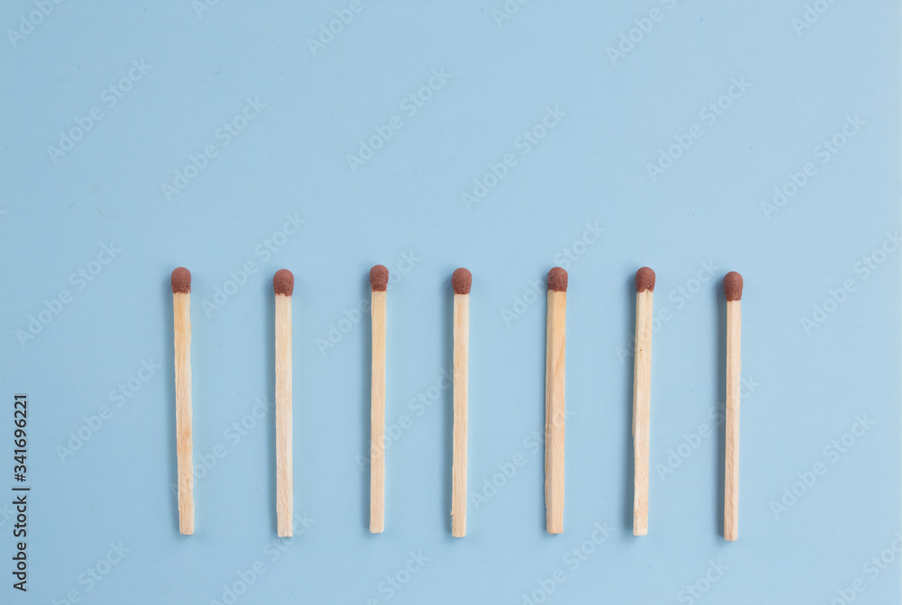 matches in a row on a blue background, down arrow from matches. Top view. Mock up. Flat lay composition matches in a row on a blue background, down arrow from matches. Top view. Mock up. Flat lay composition