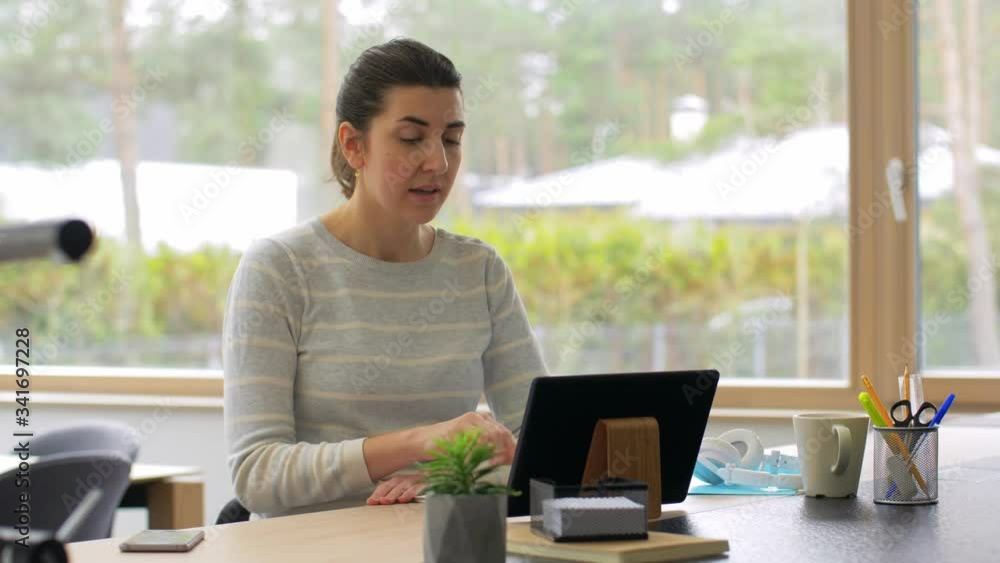 remote job, business and people concept - smiling young woman with tablet pc computer having online video conference working at home office remote job, business and people concept - smiling young woman with tablet pc computer having online video conference working at home office