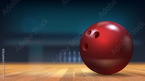 Close-up red shiny ball in bowling alley on wooden floor with blurry background