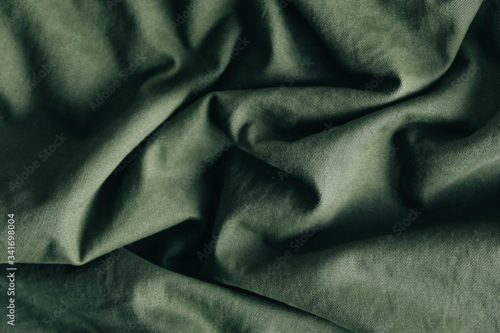Green fabric texture as background image. Top view. Copy, empty space for text Green fabric texture as background image. Top view. Copy, empty space for text
