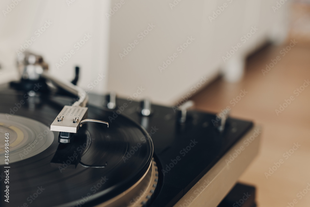 Vinyl record player with a record album and an amplifier. Cozy and warm atmosphere at home. Vinyl record player with a record album and an amplifier. Cozy and warm atmosphere at home.