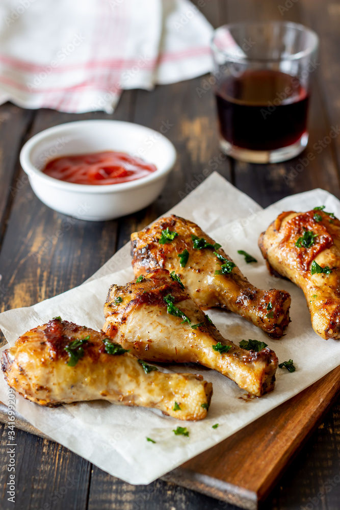 Chicken legs on a wooden background. Barbecue. Grill. American cuisine. Recipe. Rustic. Chicken legs on a wooden background. Barbecue. Grill. American cuisine. Recipe. Rustic.