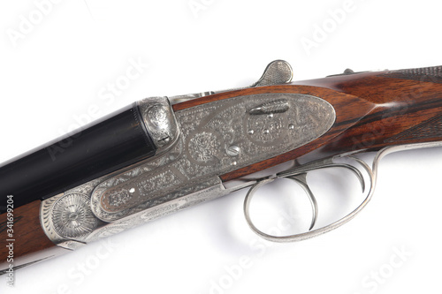 Side-by-side double-barreled spanish hunting shotgun isolated on white background