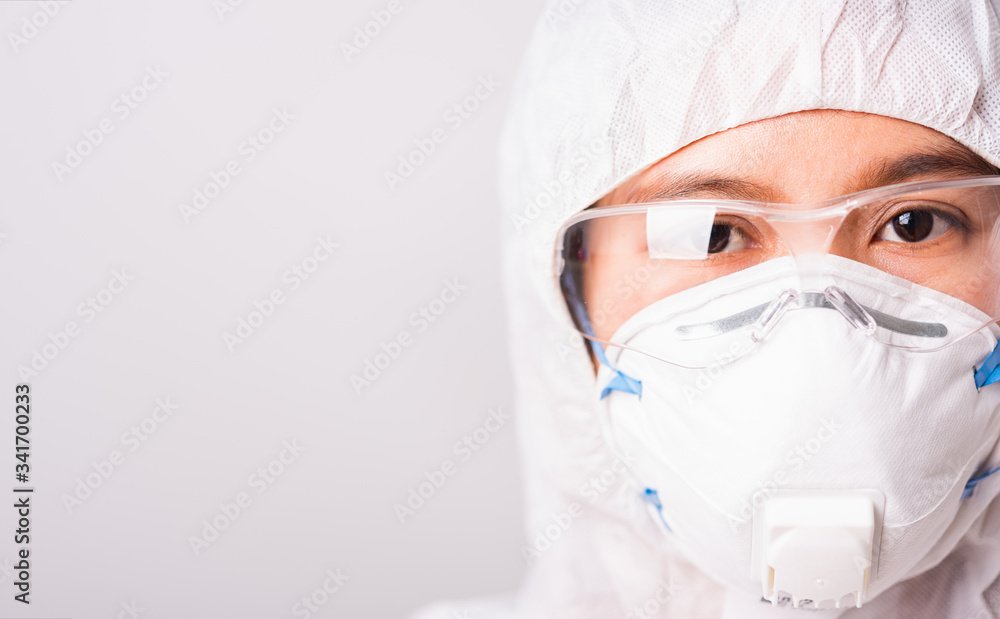 woman doctor or scientist in PPE suite uniform wearing face mask N95 protective woman doctor or scientist in PPE suite uniform wearing face mask N95 protective