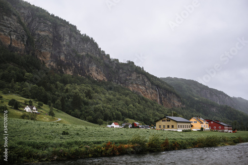 Norwegian landscape with local houses. Northern village on the background of the forest