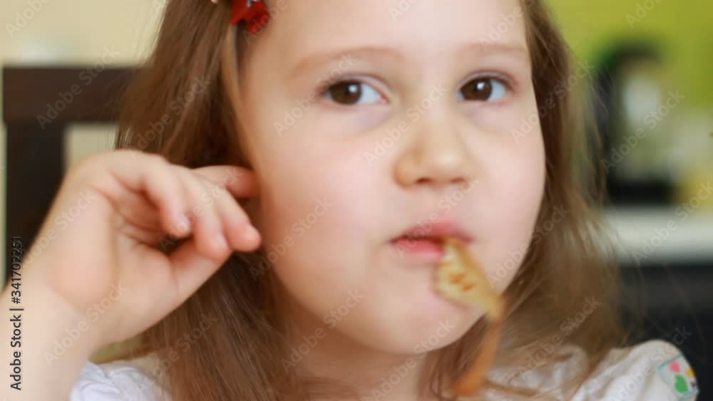 Child eating pancakes for breakfast. Food and diet Child eating pancakes for breakfast. Food and diet