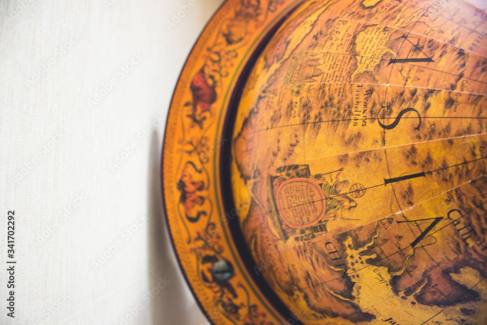 Naklejka premium wooden globe on wooden surface