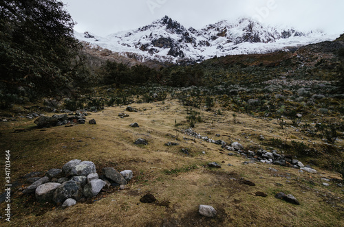 surroundings of the base camp of the alpamayo mountain in the quebrada santa cruz in peru, with snowy mountains in the background