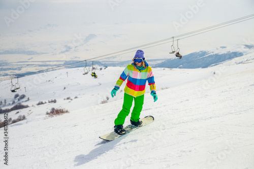 Girl snowboarding on the ski slope in Tsakhkadzor (Tsaghkadzor), Kotayk Province, Armenia